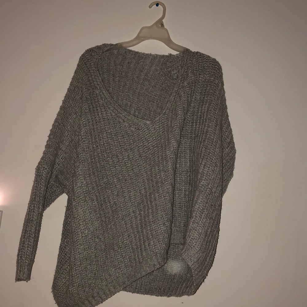 a grey thick fall sweater.